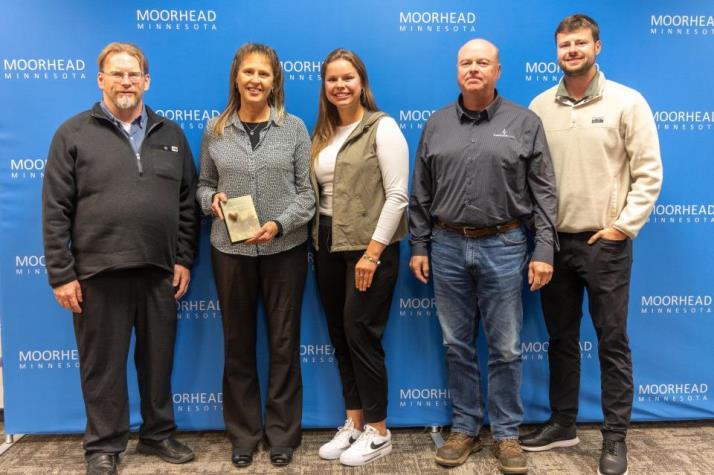 This photo shows Amy Ricco and her family as she wins the MoorHeart Award