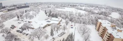 An aerial view of Moorhead during winter, featuring the Hjemkomst