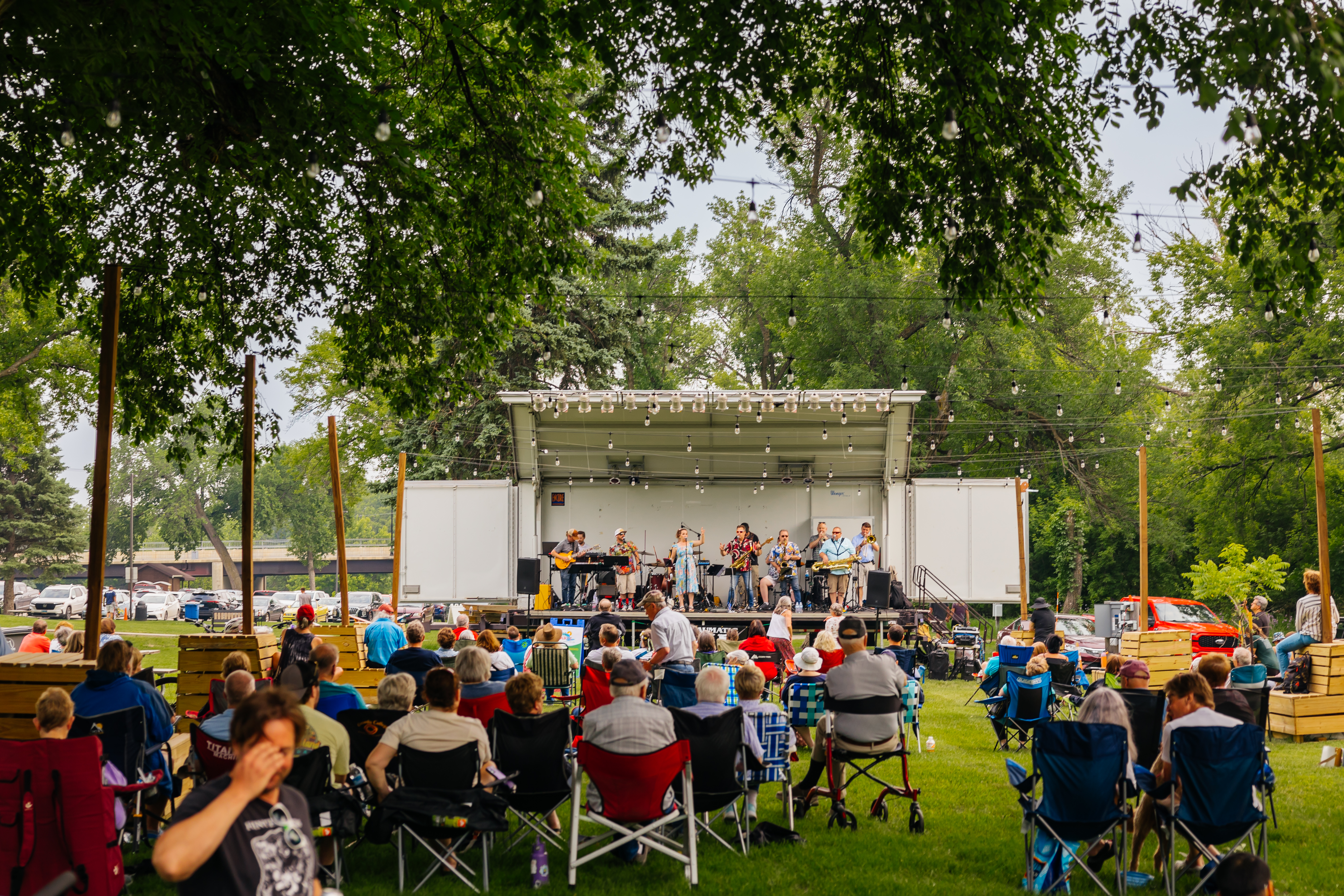 River Arts event featuring band and crowd in the park 