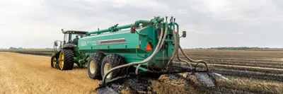 a tractor fertilizes a local field