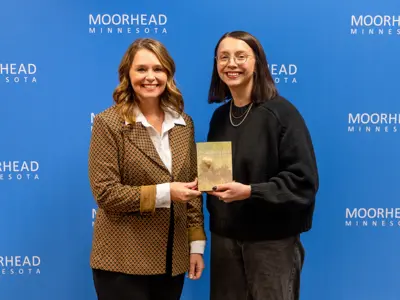 Sydni Kreps accepts the MoorHeart award with Mayor Carlson