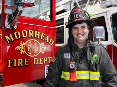 Ryan in his fire gear outside of a fire truck