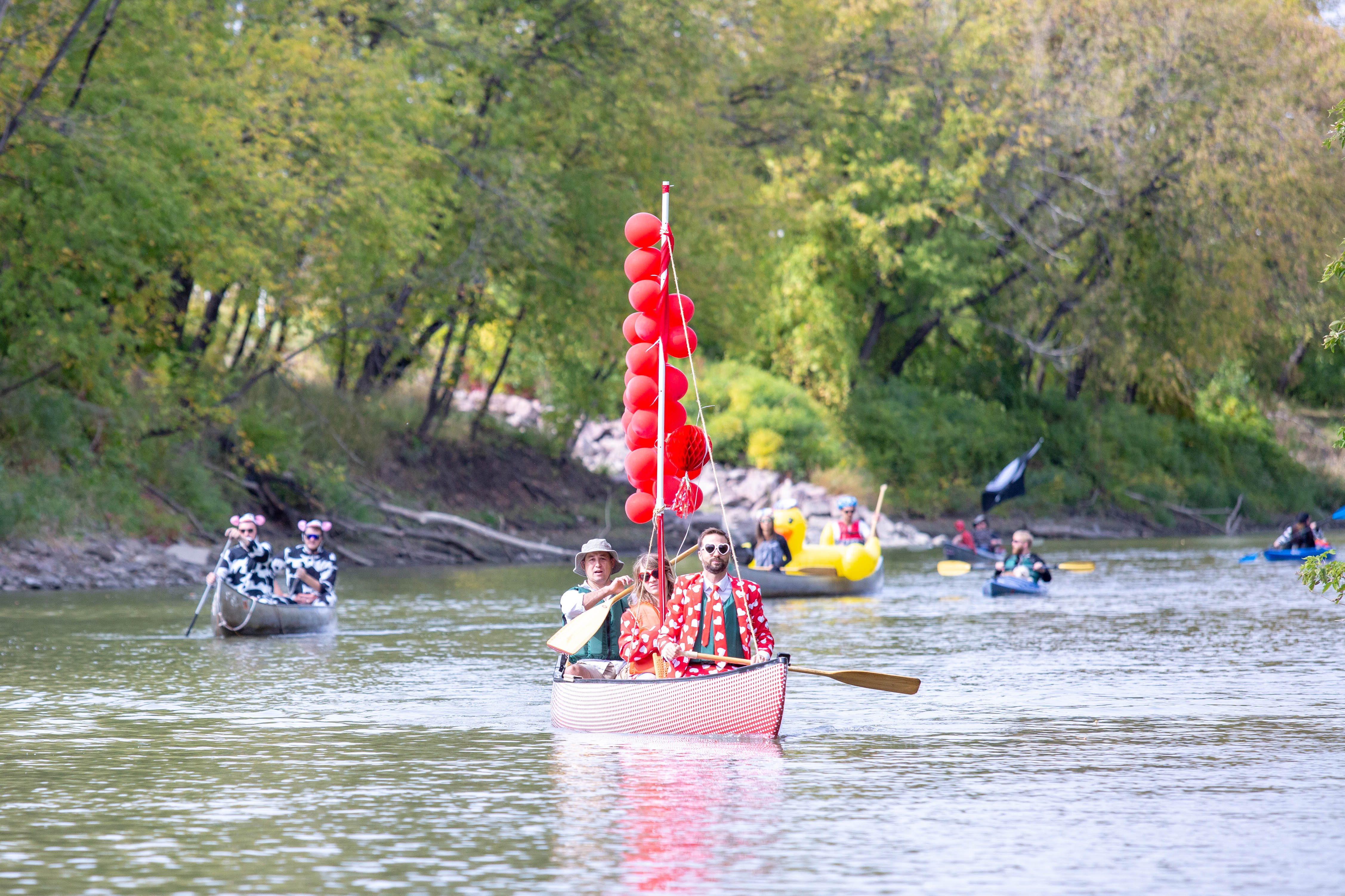 people canoe down the river