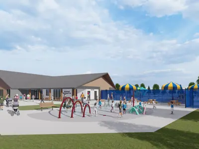 A building in the background and a splash pad in the foreground 
