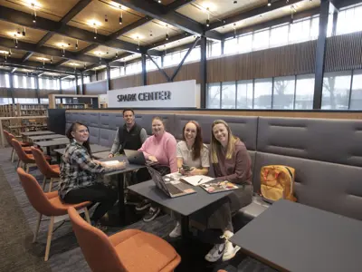 A group poses for a photo in the Spark Center space