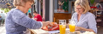 two people play a game at an outdoor patio