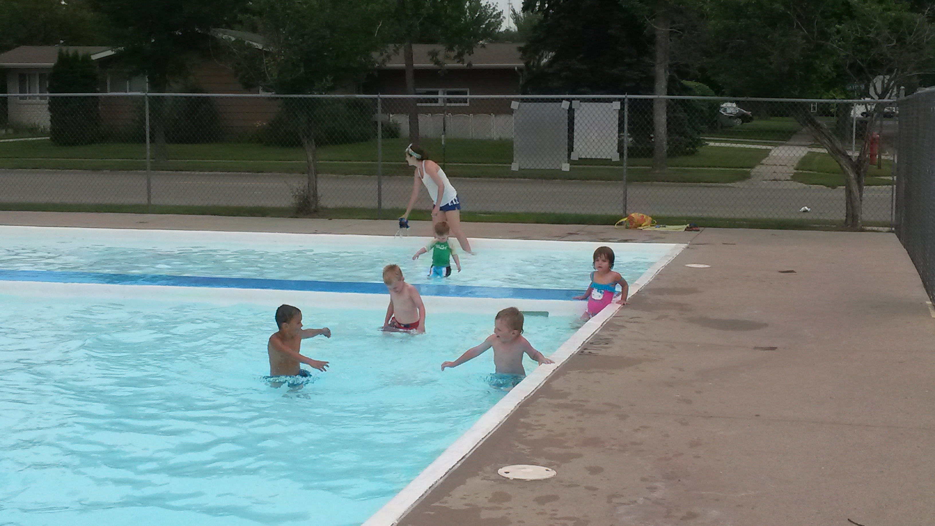 A photo of children playing in a wading pool