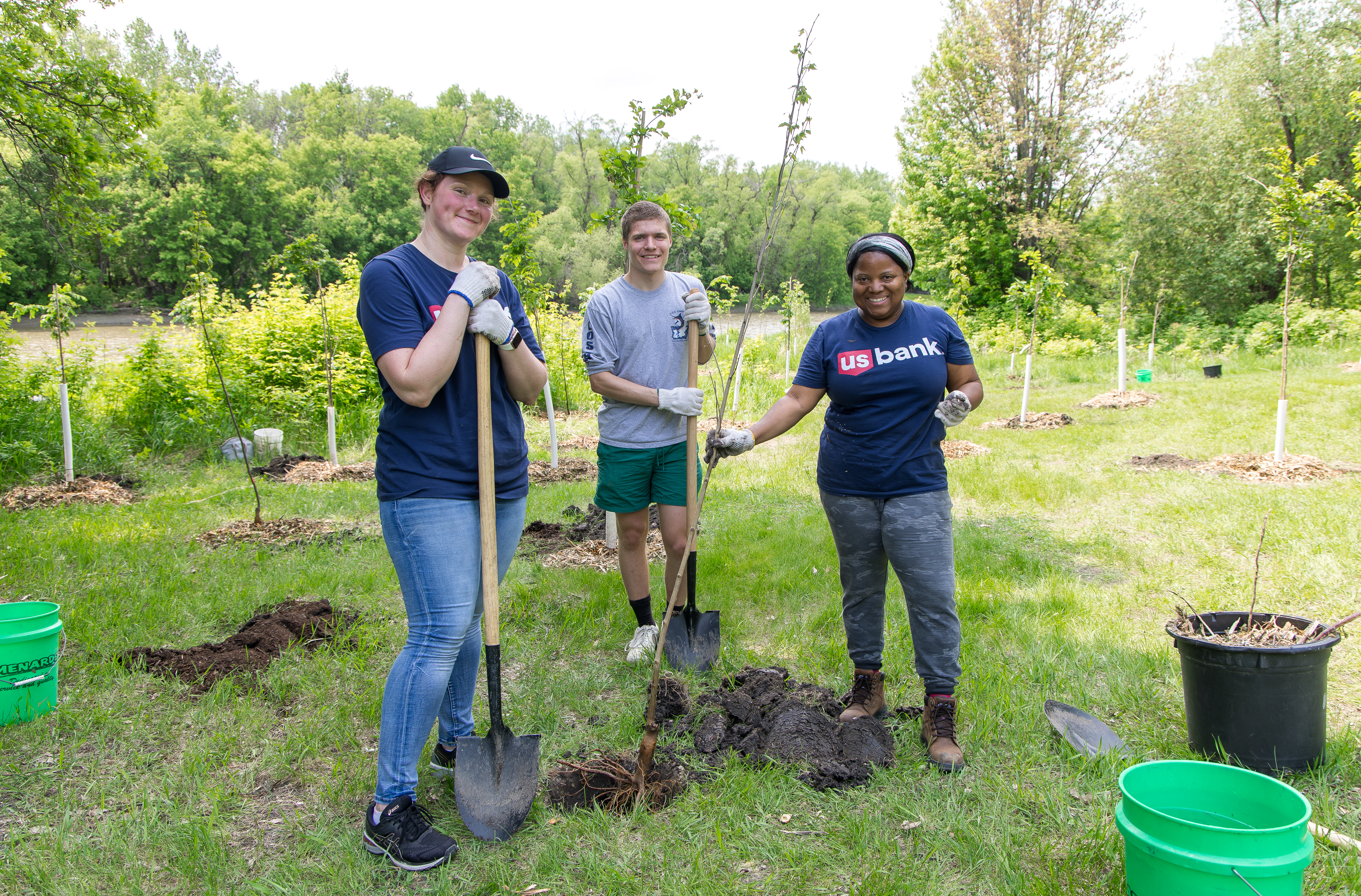 volunteers plant trees at a RiverKeepers Reforest the Red Event