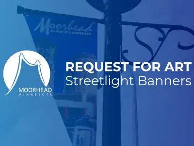 A streetlight banner with a blue hue over it and the words request for art streetlight banners in white with the City of Moorhead logo also in white