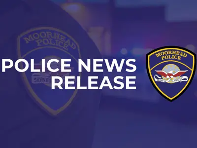 blue hued image of a police officer's badge with lights from the squad car flashing and the words Police News Release with the Moorhead Police Department logo