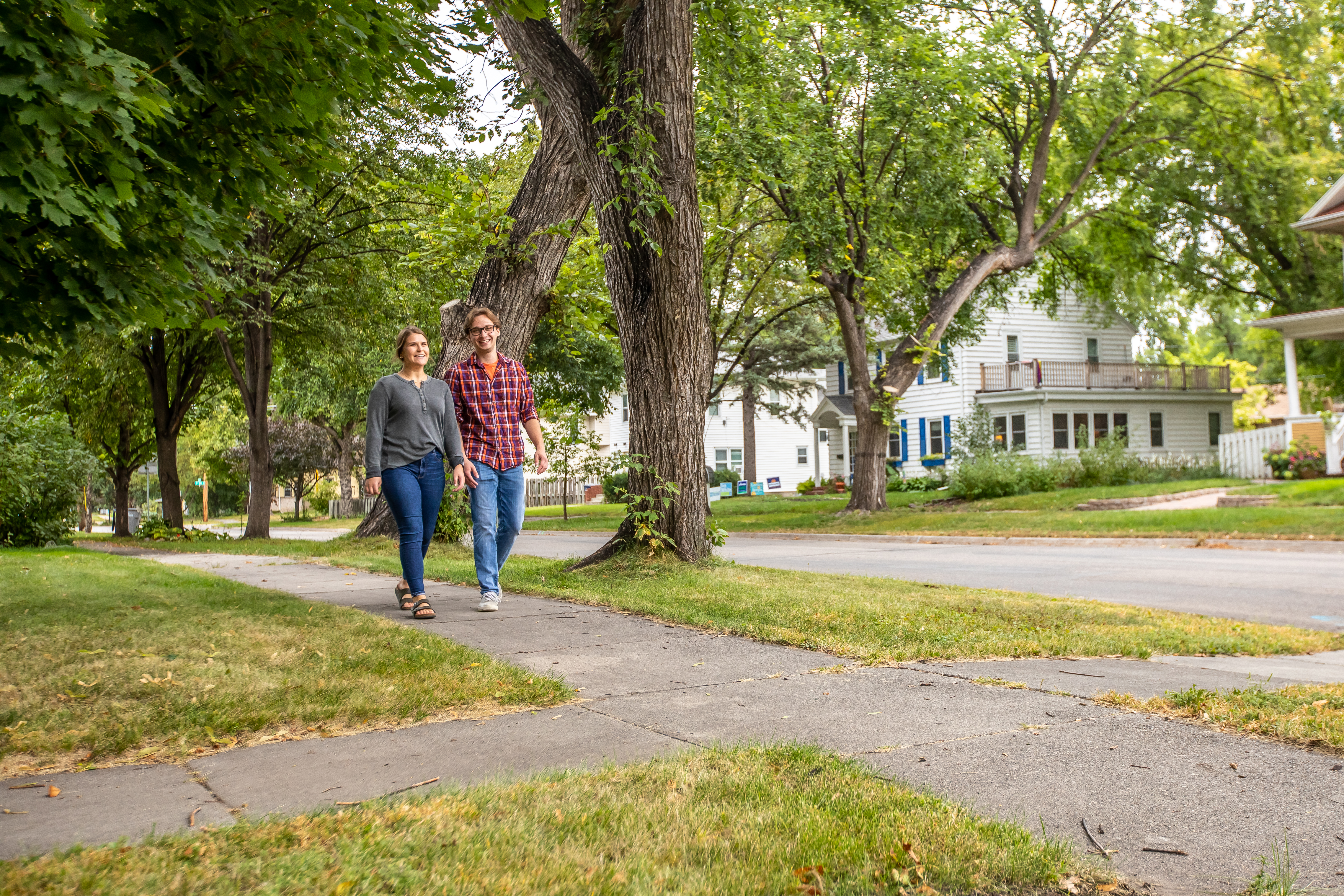 two people walking in a neighborhood