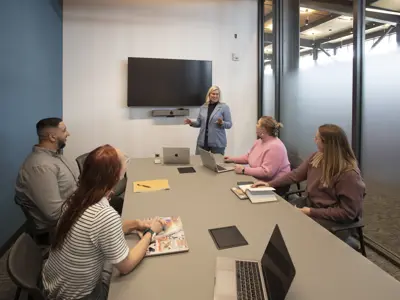 A meeting is happening in the meeting room space